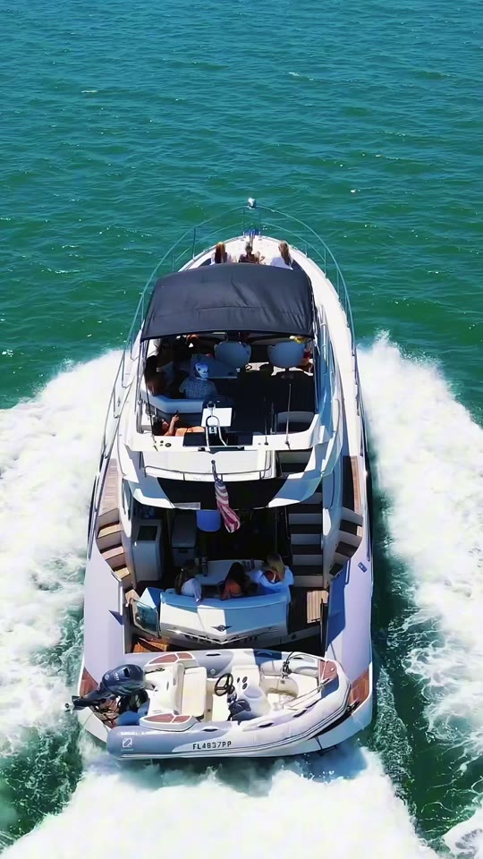 Aerial drone orbit of the 52ft Marquis Flybridge cruising Tampa Bay