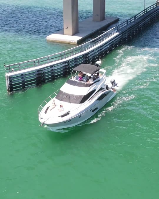 Aerial drone view of the 52ft Marquis Flybridge running through the pass toward Shell Key, St. Petersburg FL