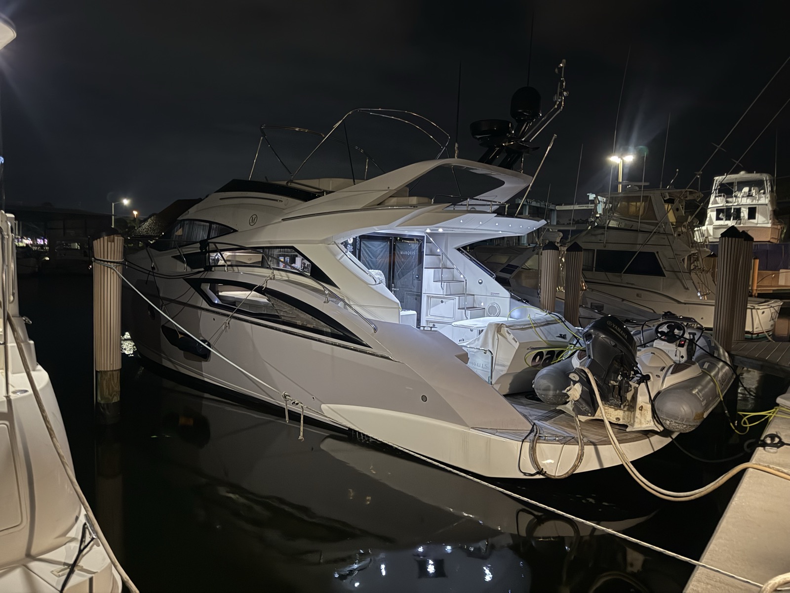 52ft Marquis Flybridge yacht illuminated at twilight after sunset cruise